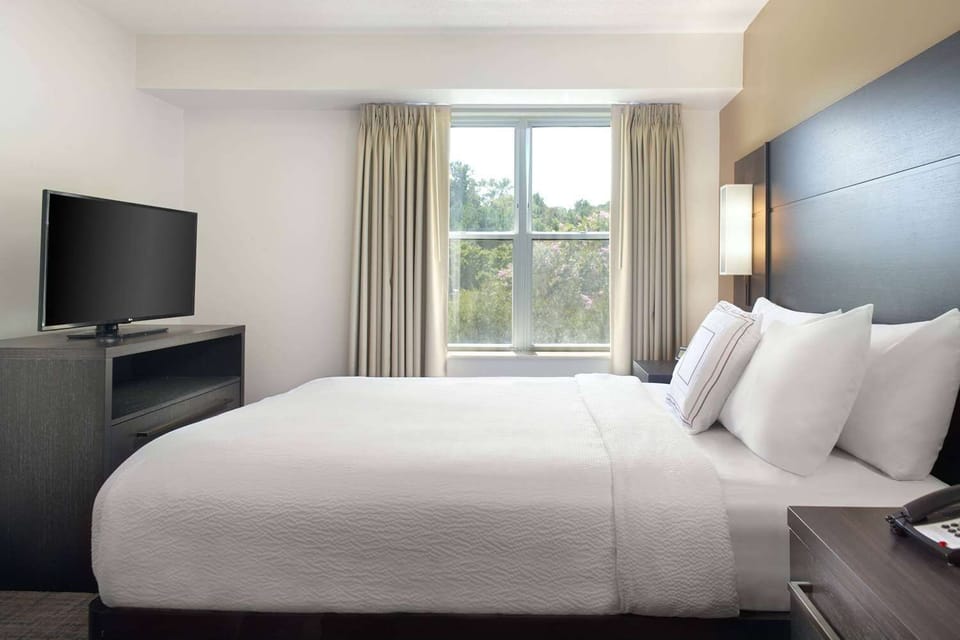 Drift off in a serene bedroom with soft natural light.