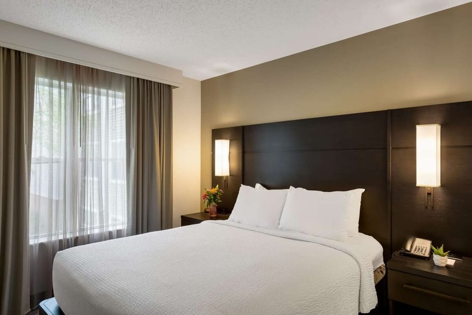 Drift off in a serene bedroom with airy natural light.