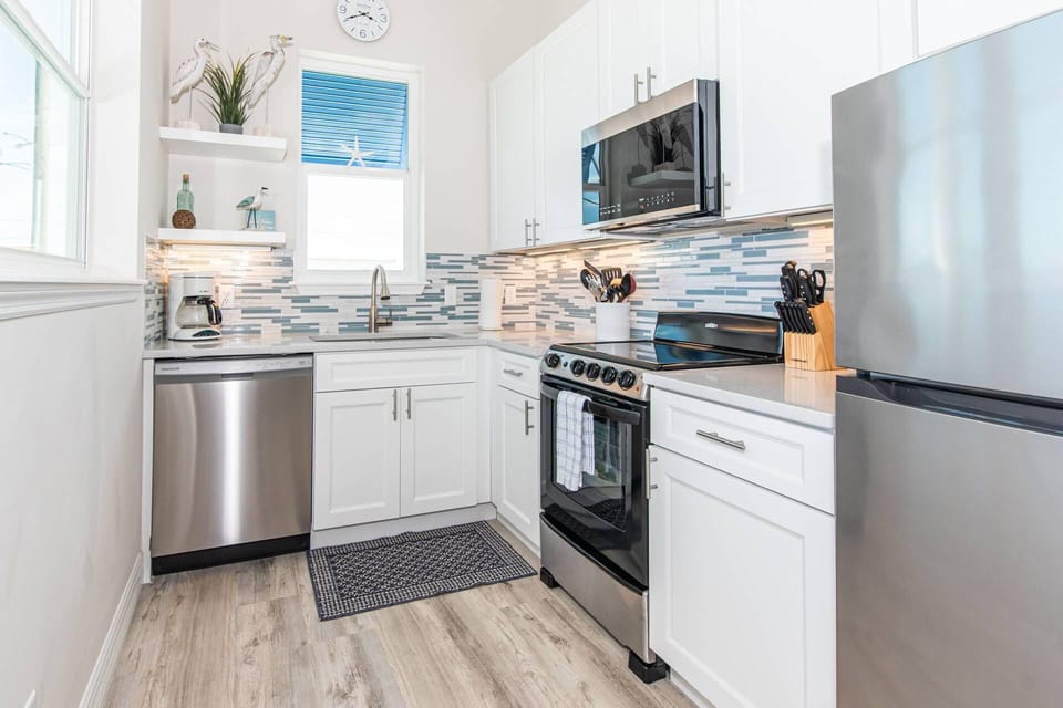 Prepare meals effortlessly, the kitchen features sleek stainless steel appliances for modern convenience.