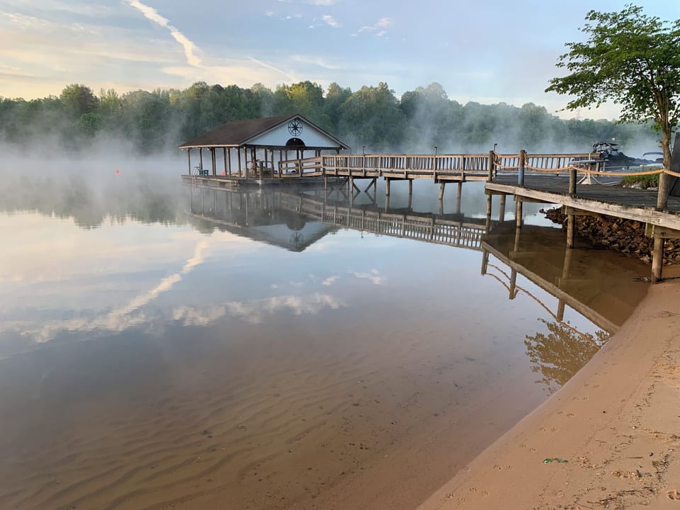 Boathouse & boardwalk from the beach--clear water w/gently sloped, sandy bottom.