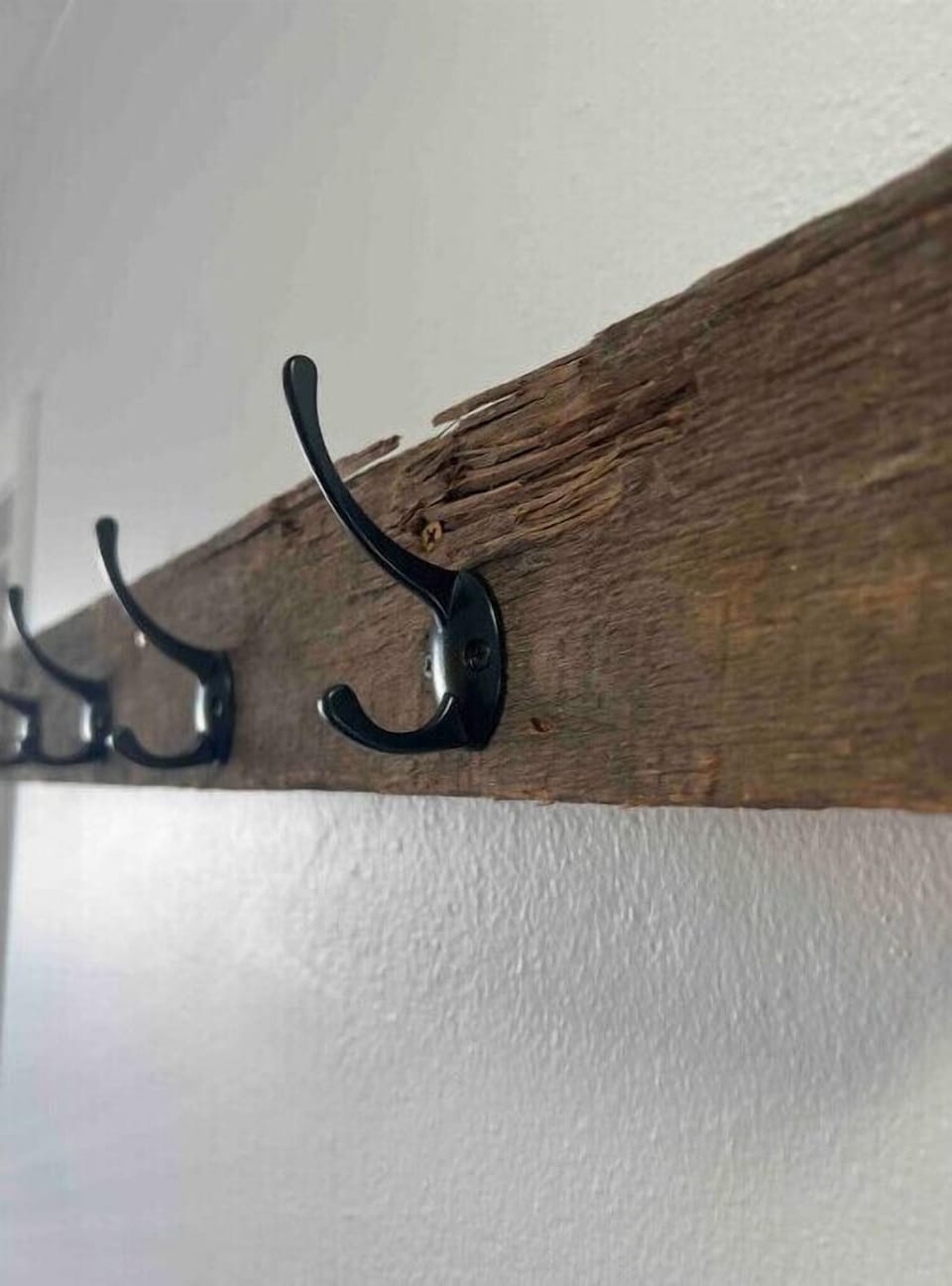 Original 2x4 from1895 that we repurposed into a coat rack. 