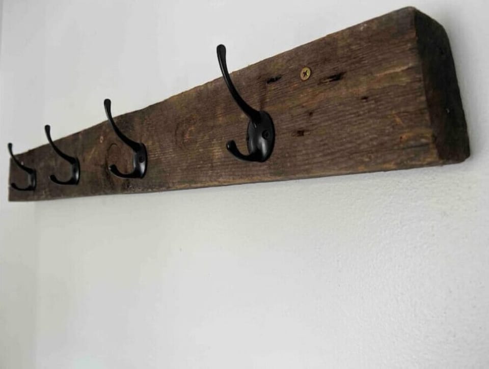 Original 2x4 from1895 that we repurposed into a coat rack. 
