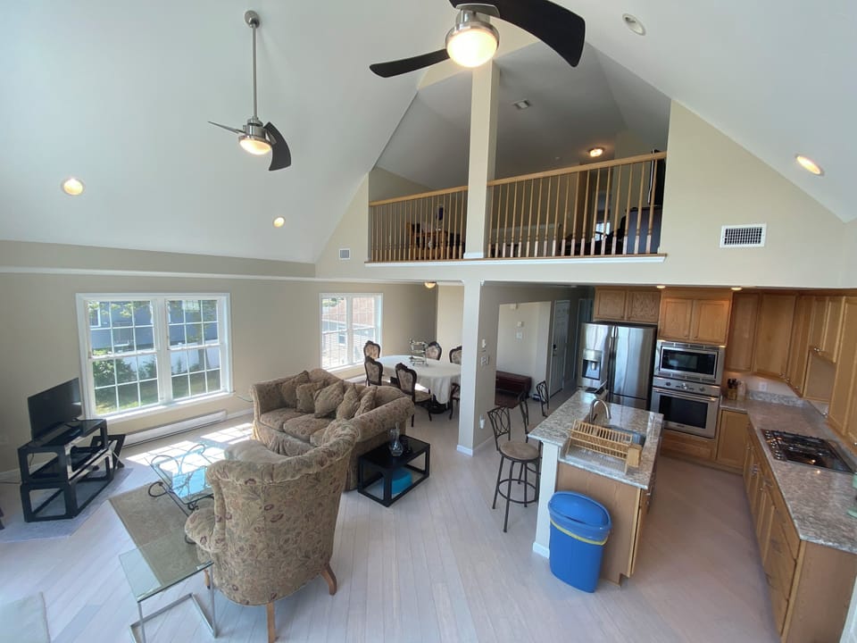 Cathedral ceiling grand space, includes living space, kitchen, bar and dining
