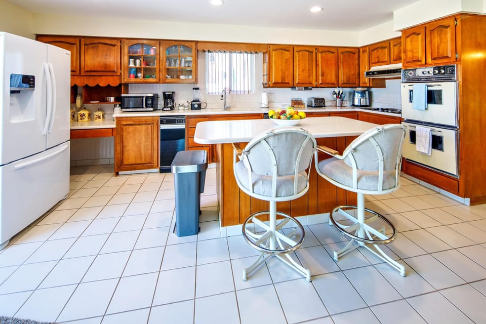 kitchen seating looking over the game room and patio