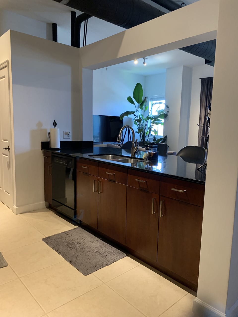 Kitchen Island with sink and view of living room television. 
