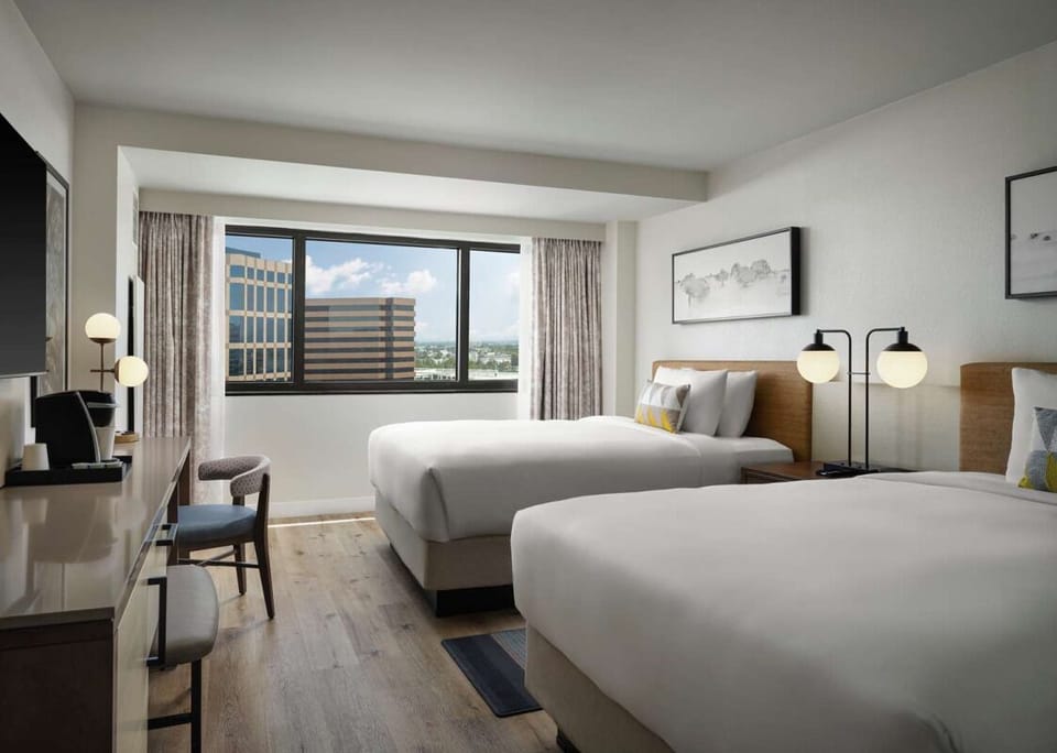Unwind in bright double-queen comfort with sweeping city views.