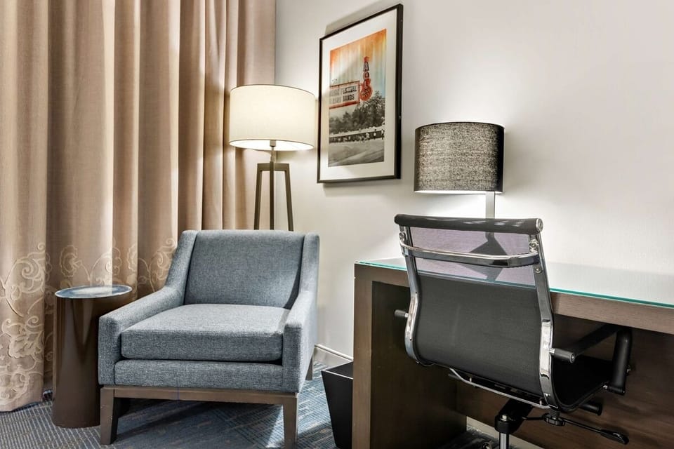 Settle into a cozy chair and productive in-room workspace.