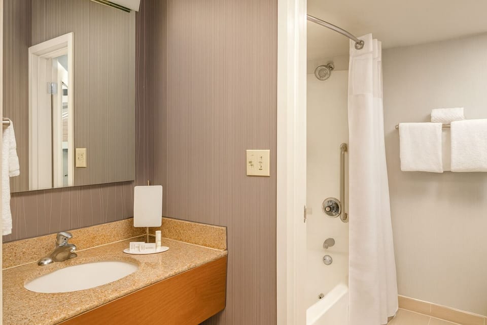 Refresh with a clean vanity and soothing shower setup.