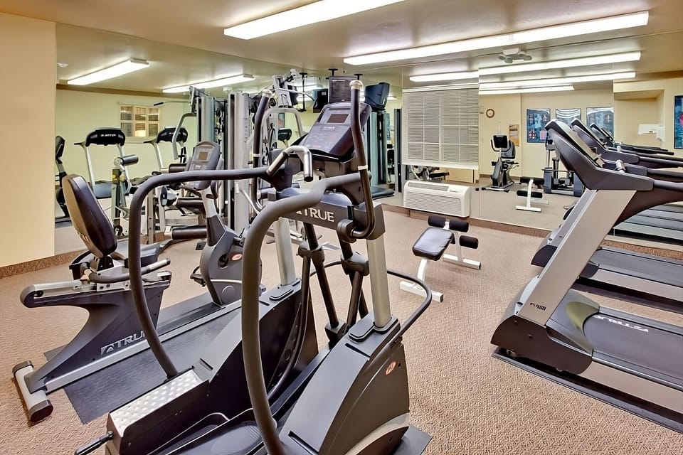 Energize your day with a bright, well-equipped fitness room.