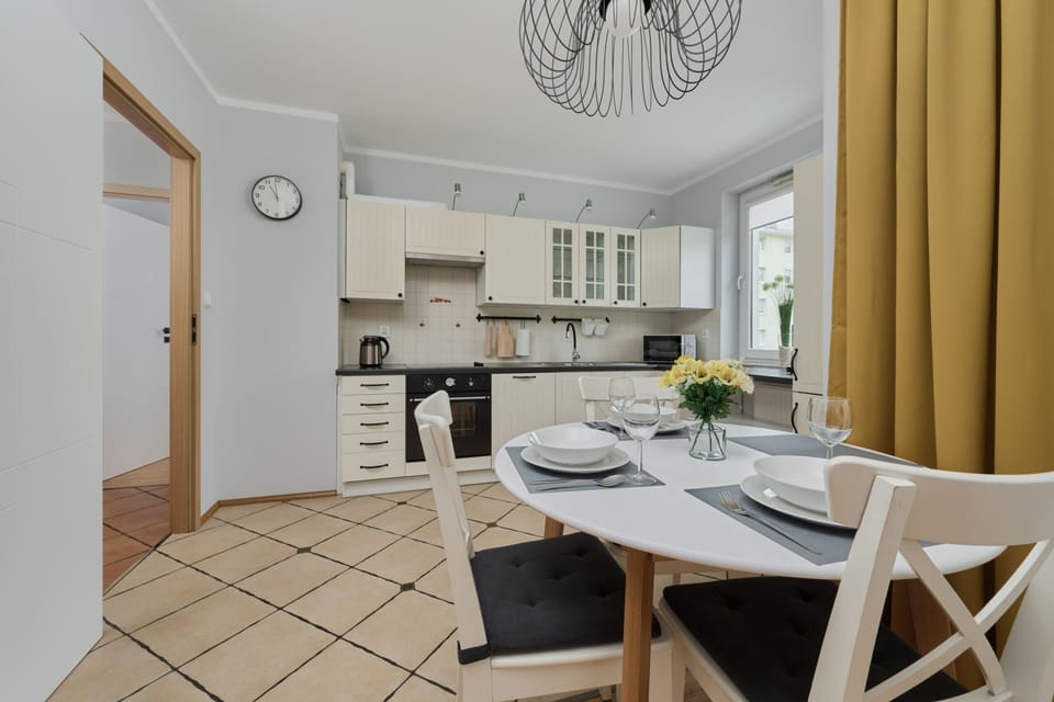 A dining area and kitchen, emphasizing the open-plan design and the bright, airy atmosphere.
