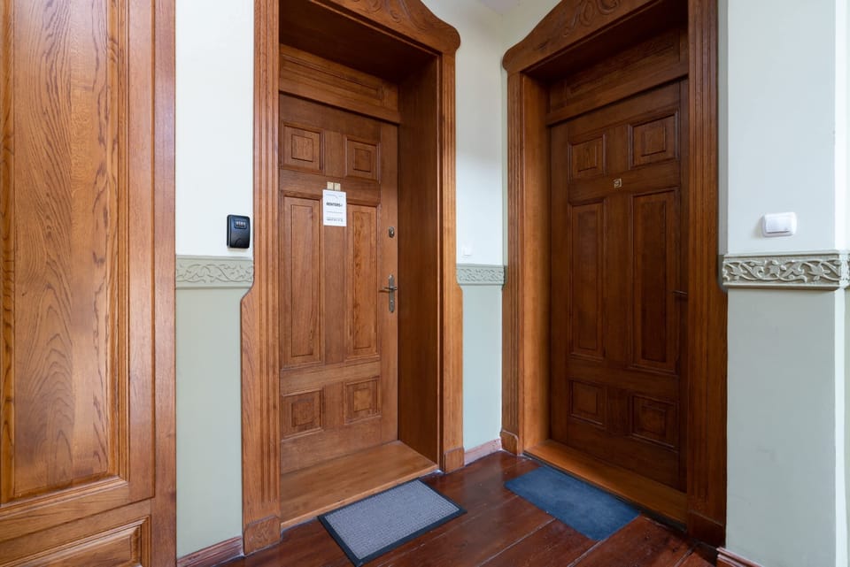 A pair of beautiful wooden doors leading into the building, reflecting the historic charm of the property.
