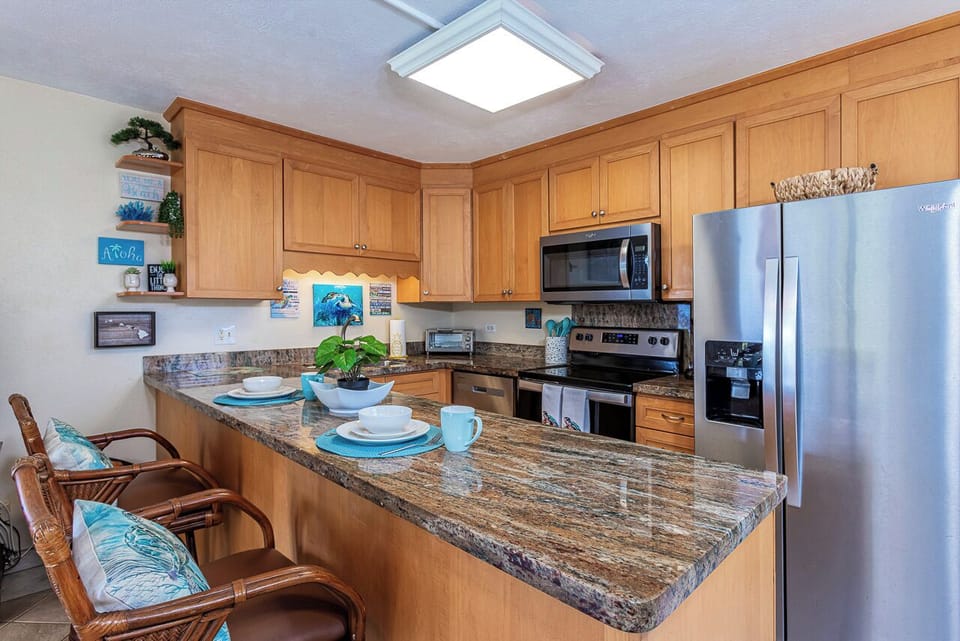 Picture yourself preparing meals in this fully equipped kitchen with granite counters, stainless appliances, and cheerful coastal touches. Enjoy your morning coffee at the breakfast bar with seating for three.