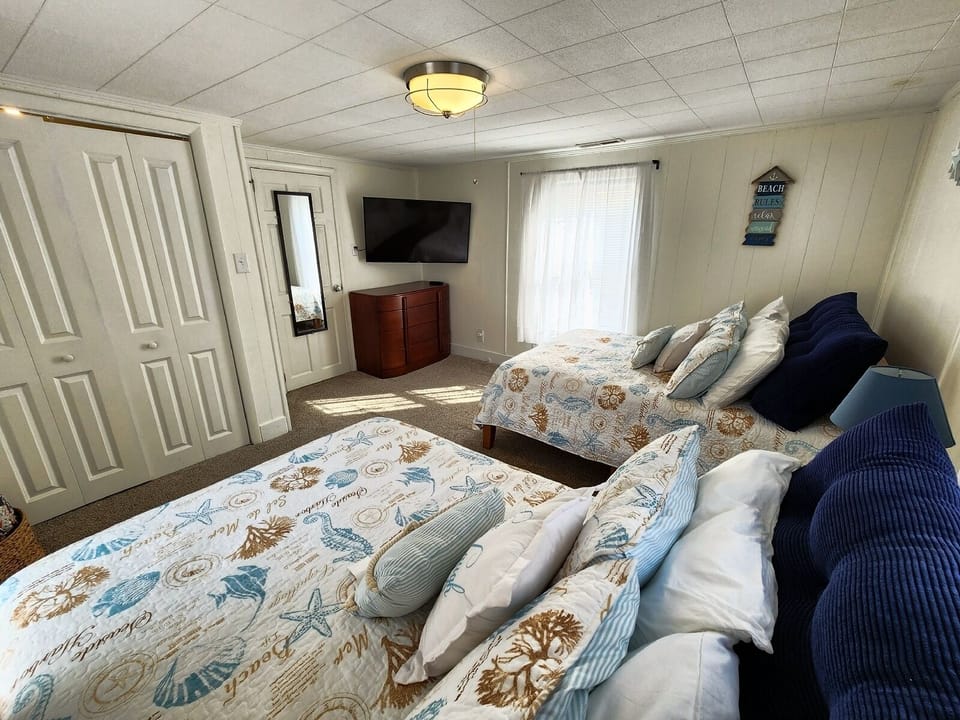 Comfortable bedroom with two full beds, perfect for family or friends.