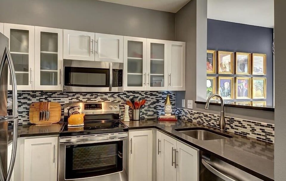 Gourmet kitchen with newer cabinets, quartz counters and Stainless-Steel appliances.