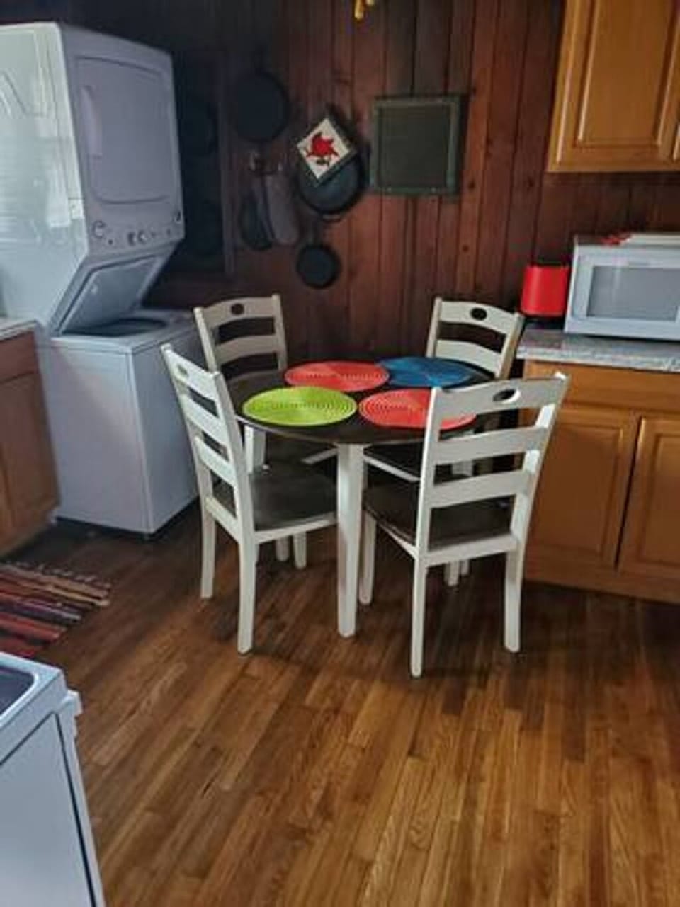 Kitchen with wooden table, 4 chairs and washer/dryer