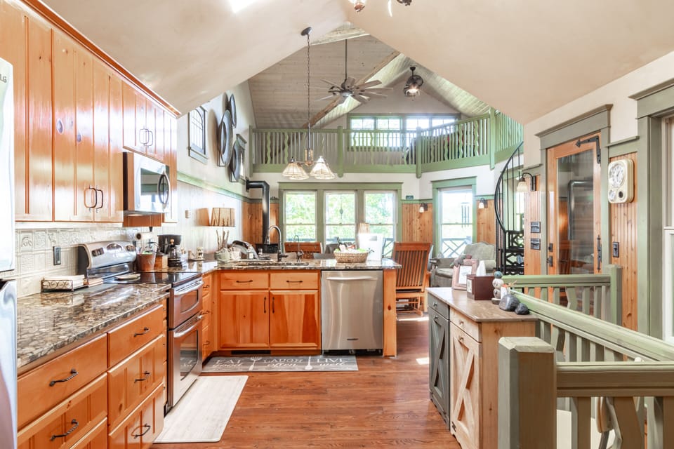Open concept kitchen with custom river bottom rock cut granite countertops