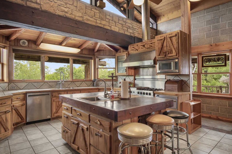 The kitchen's central island, complete with its own sink, provides even more meal prep and presentation space!