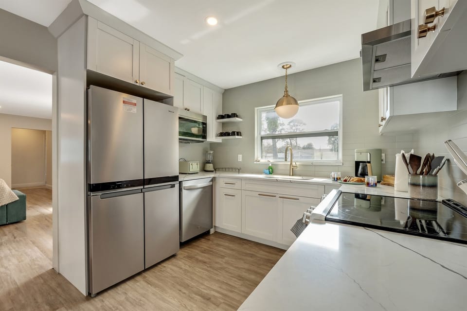 The kitchen welcomes you with its spacious layout, offering ample room for culinary endeavors and social gatherings alike.