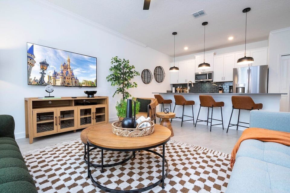 Welcome to our spacious and beautifully adorned living room, complete with a state-of-the-art smart TV where you can stream all your favorite channels and shows. 