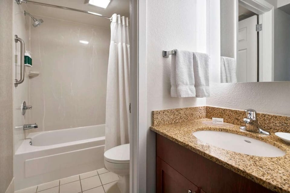 Refresh easily with a spotless bath, plush towels, and vanity.