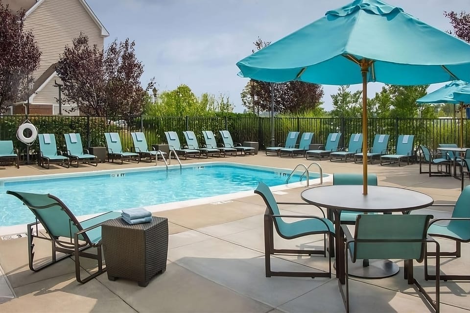 Dive into sunny relaxation with loungers and sparkling pool water