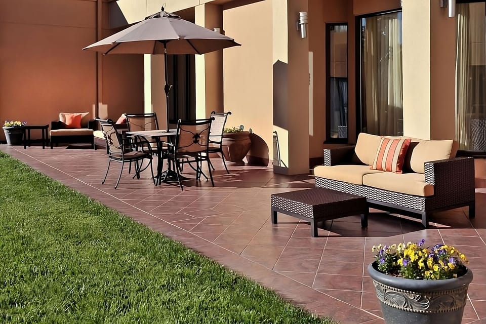 Sip coffee outside on the sunny patio lounge seating.