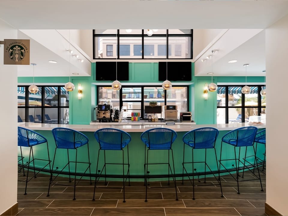 Sip morning coffee at the vibrant bar before exploring.