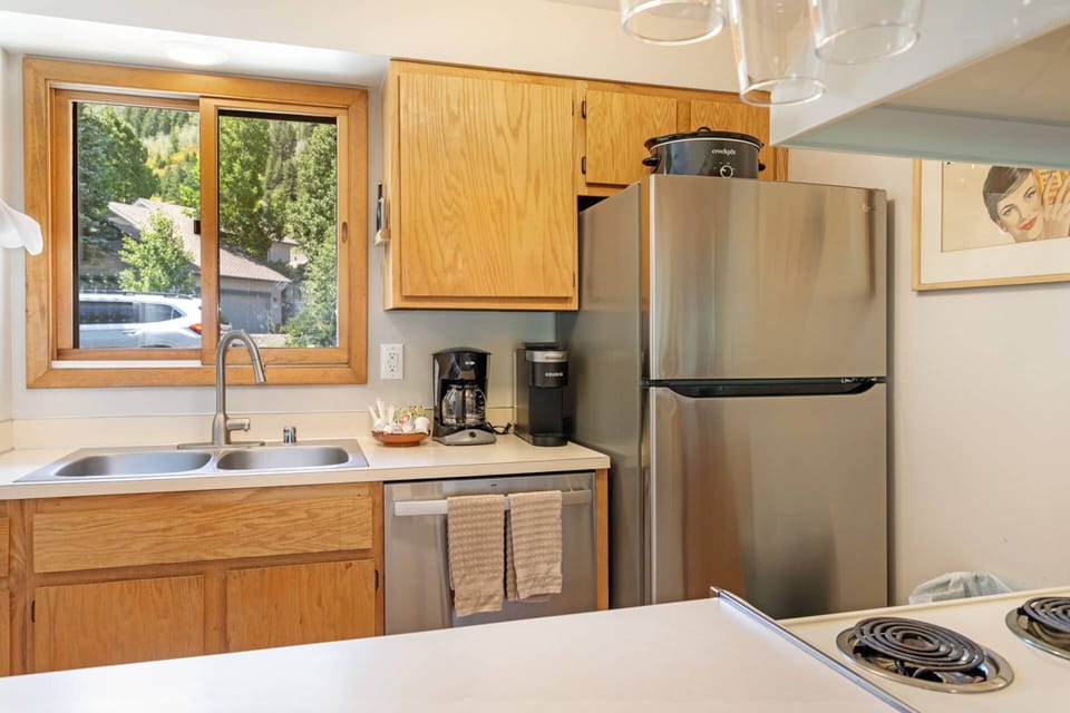 Kitchen features a Refrigerator, Dishwasher, Electric Range and Fully Stocked Coffee Bar