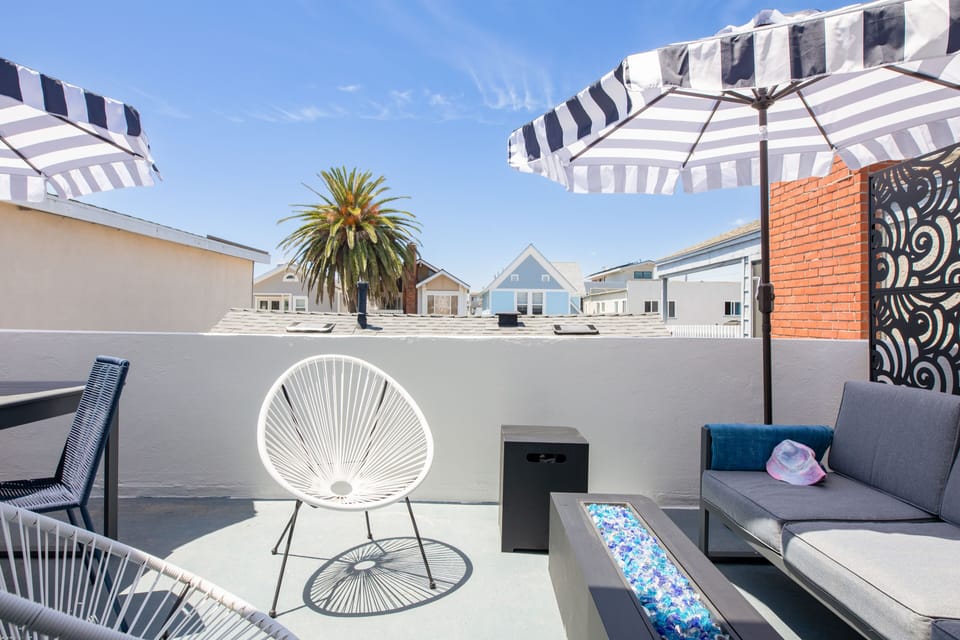 Sunny upper balcony with a firepit.