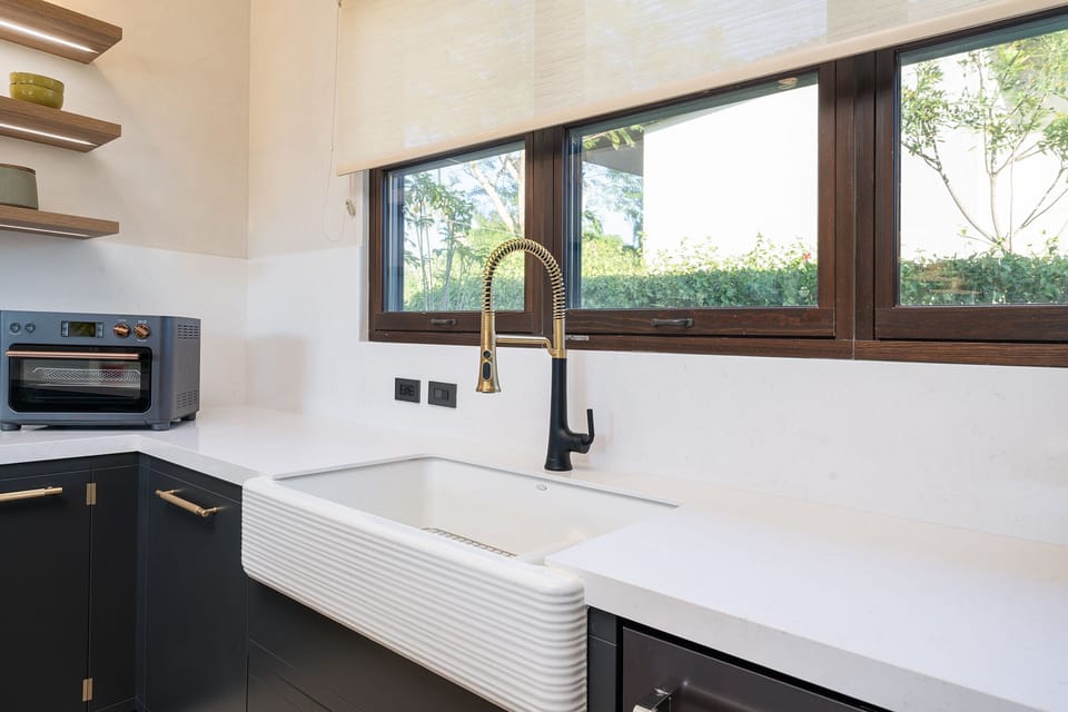 Charming farmhouse sink in the modern kitchen, perfect for preparing meals during your luxury Avellanas Beach vacation rental.