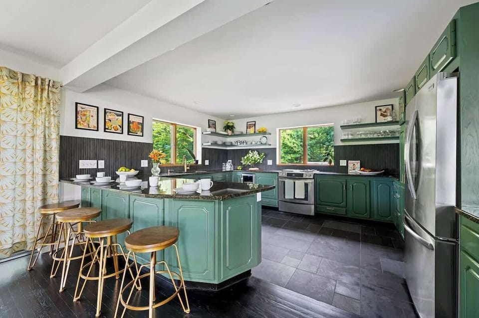 Breakfast bar & ample granite countertop space for meal prep

