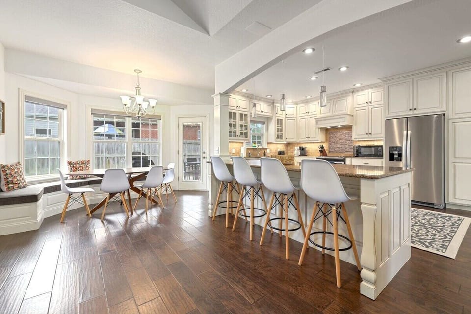 At the far end, you'll see a second dining area with bench seating and four chairs.