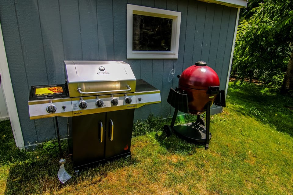 Outdoor grilling station with propane + charcoal grills, ideal for cookouts and summer nights at the lake.