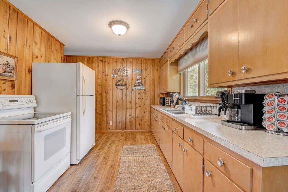 Fully equipped kitchen with coffee maker, cookware, and everything you need for home-cooked meals during your lake getaway