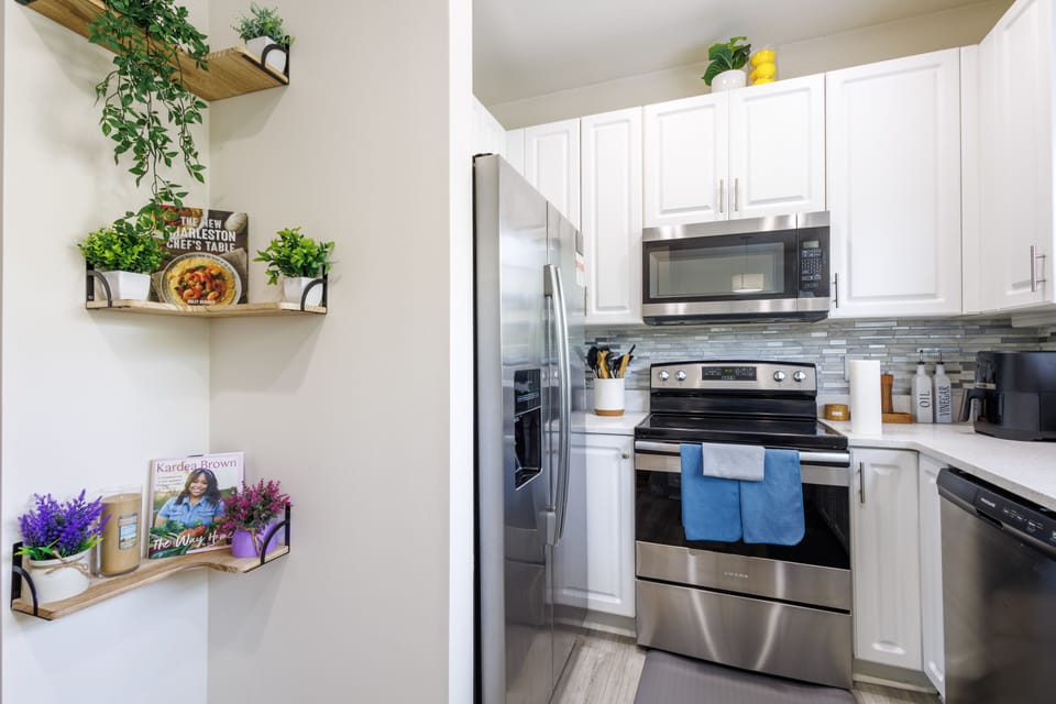 Kitchen with stainless steel appliances and cookbooks for home cooked meals!