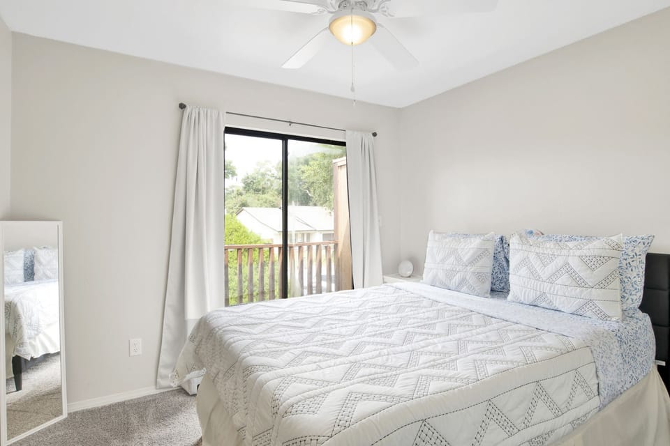 Queen bedroom with balcony access