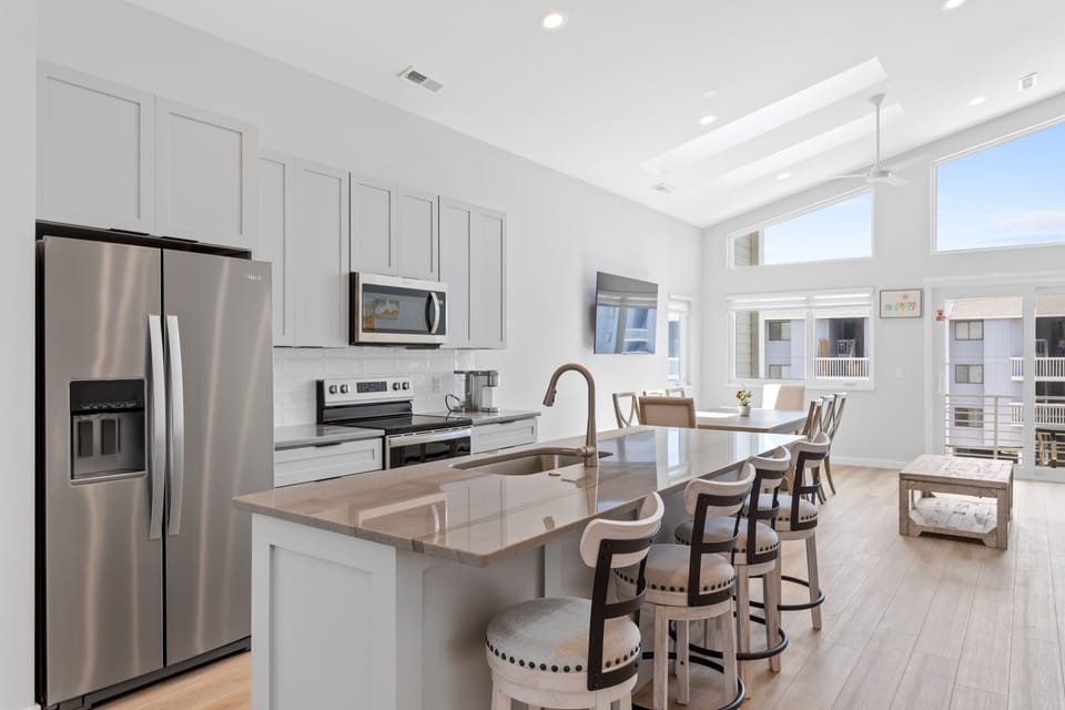 The open kitchen area with countertop seating for 4