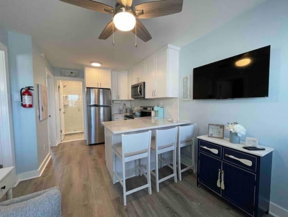 Living area open to kitchen with Roku TV 