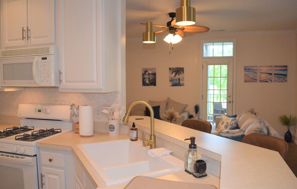 Kitchen with pendant lighting, tile backsplash  and tile flooring