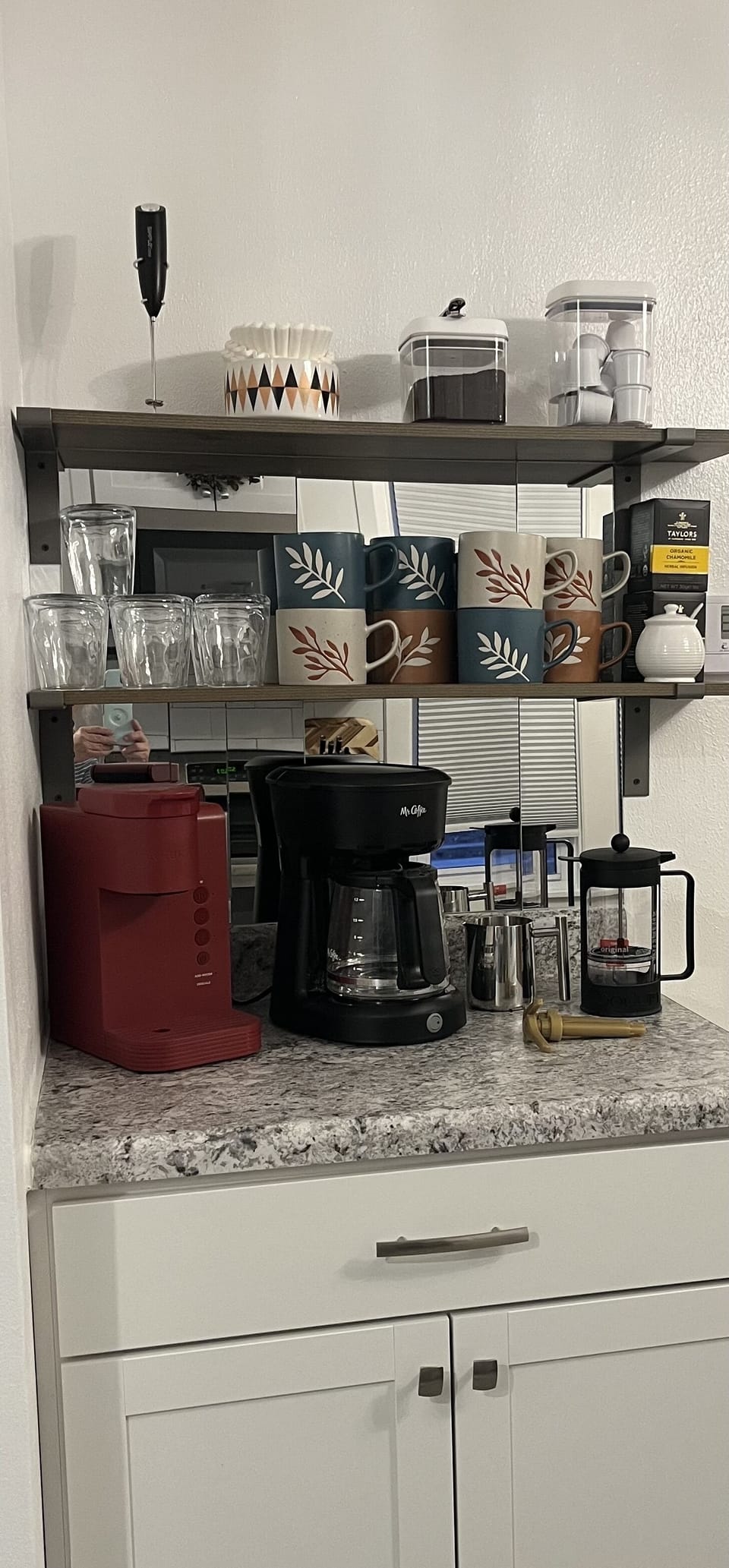 Coffee bar.
Contains k cup machine, French press, automatic drip coffee maker.