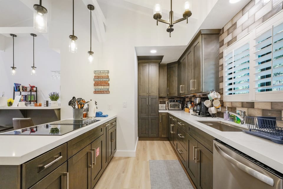 Large kitchen provides lot of storage space, and has plenty of pots and pants for meal preparation.
