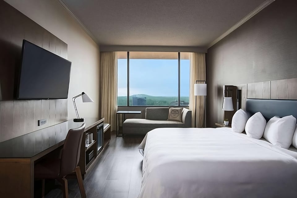 Unwind in a sunlit room with sweeping skyline views.