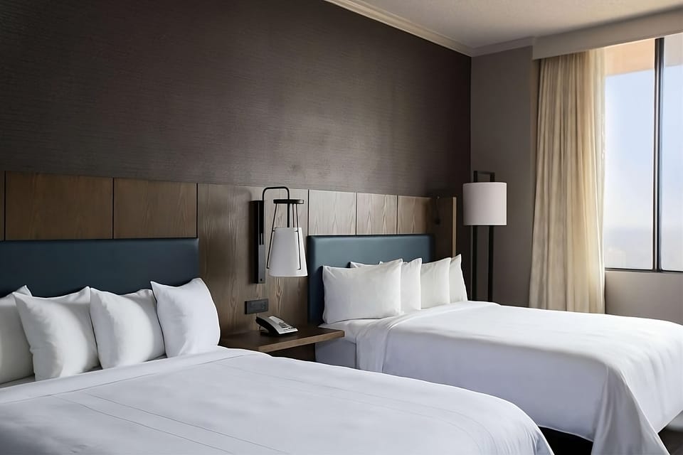 Drift off in plush double beds with soft, calming lighting.