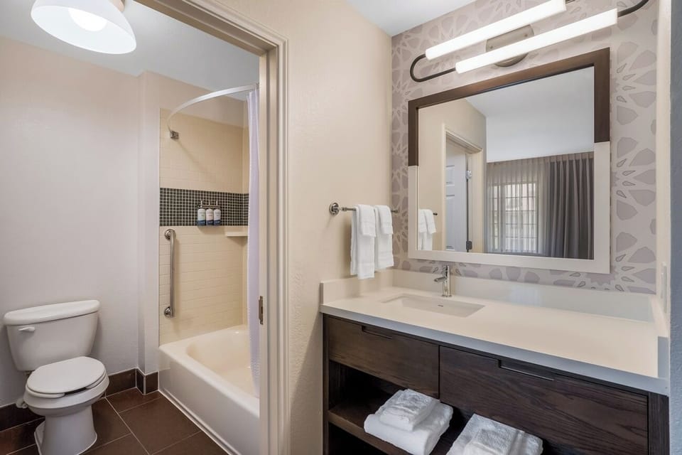 Refresh with bright vanity lighting and a spotless tub shower.
