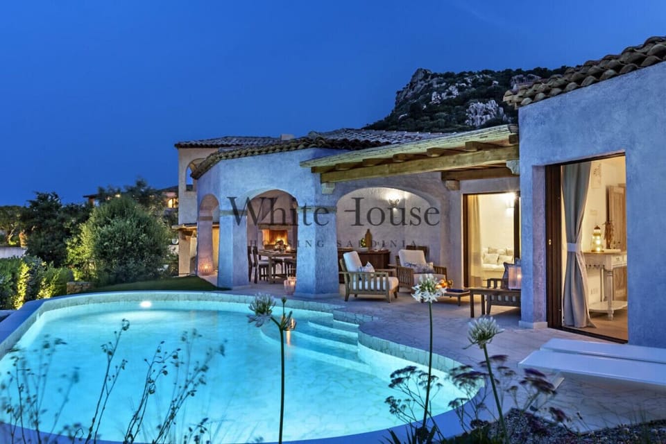 Swimming pool, sitting area and dining table outdoors