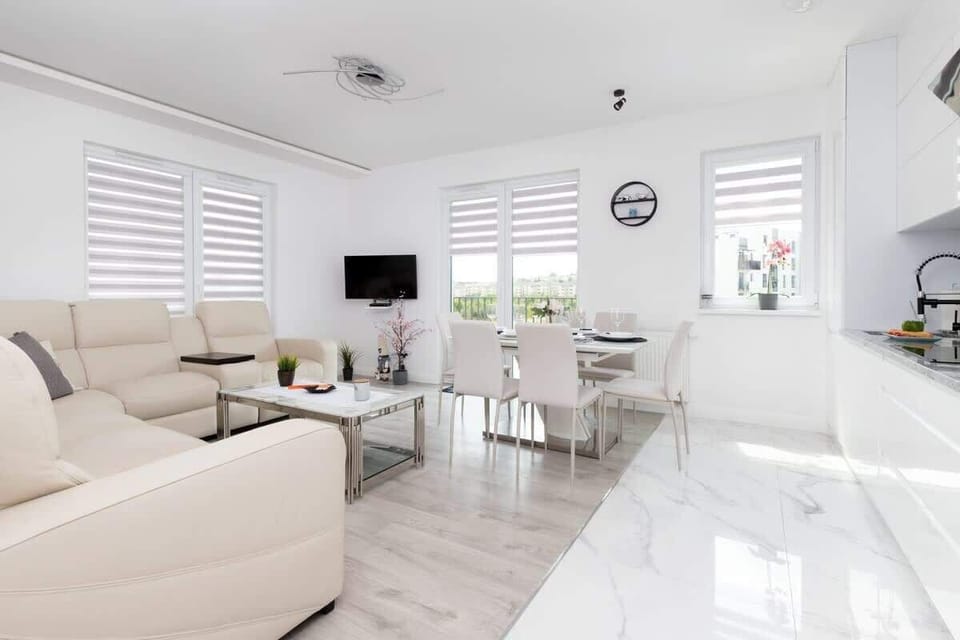 A wide-angle view of the open-plan living and dining area, highlighting the airy and modern design.
