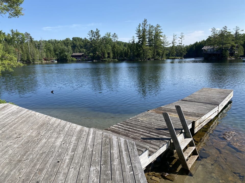 Lakeside deck and dock area with gentle ripples on the waters of Lac Dame