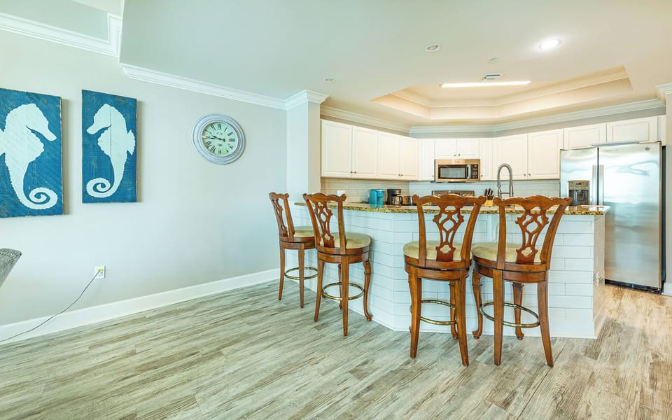 Breakfast bar with wood chairs welcomes your morning chats and fresh coffee aromas