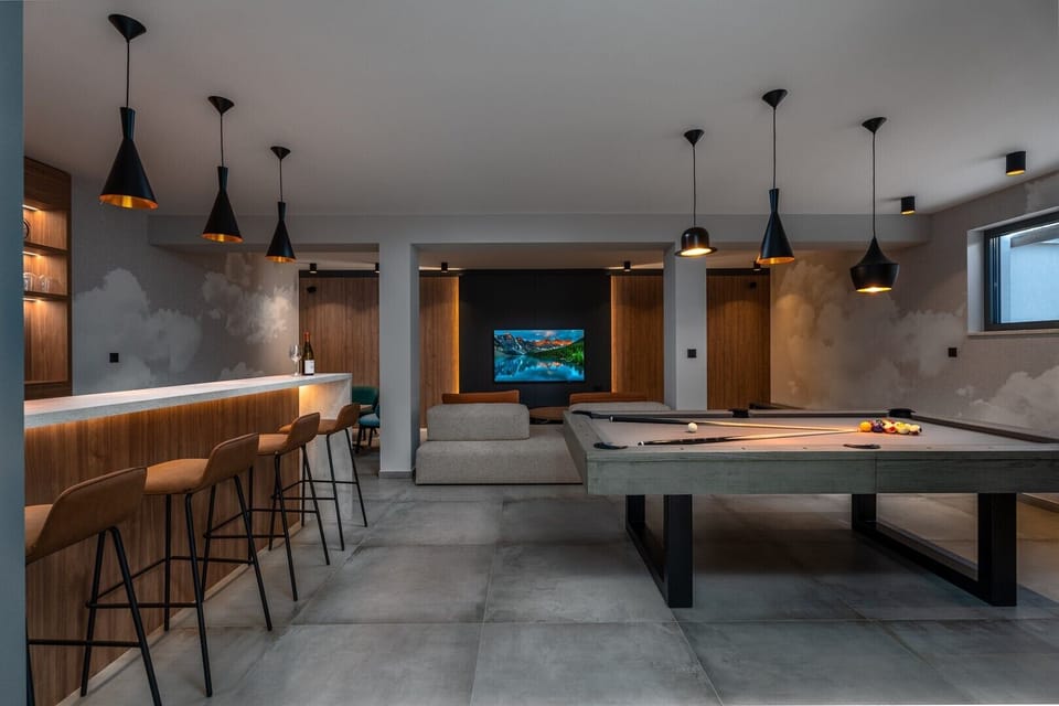 Well organized fun zone in the basement with billiards and a Media room