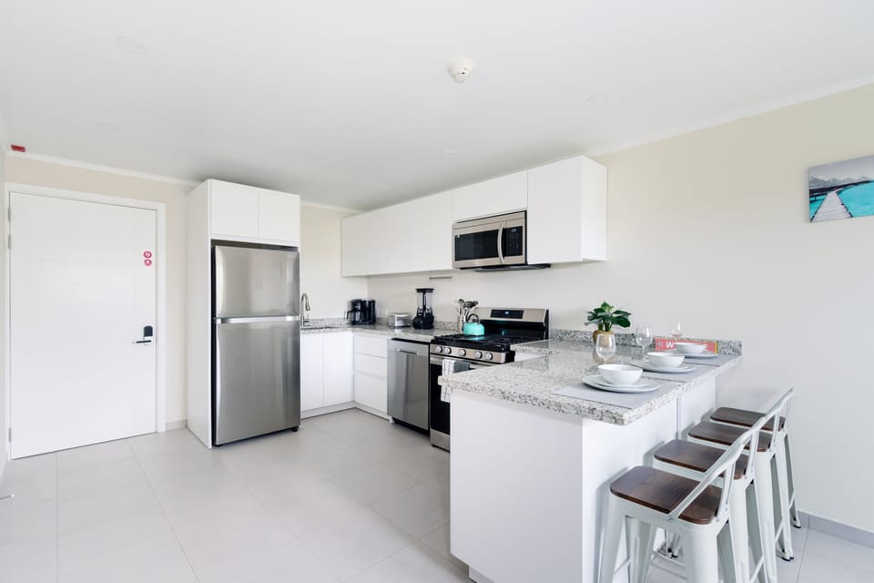 Gorgeous Kitchen of the 2-BR Condo in Noord Aruba - Smart use of space with versatile storage solutions - Open concept connecting the kitchen to the dining or living area - Thoughtful placement of kitchen essentials for easy access - Meal Bar